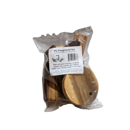 A packaged wooden playground set in a clear plastic bag with a white label reading 'PG Playground Set'. The set includes natural wood pieces such as a round platform and smaller components visible through the packaging.