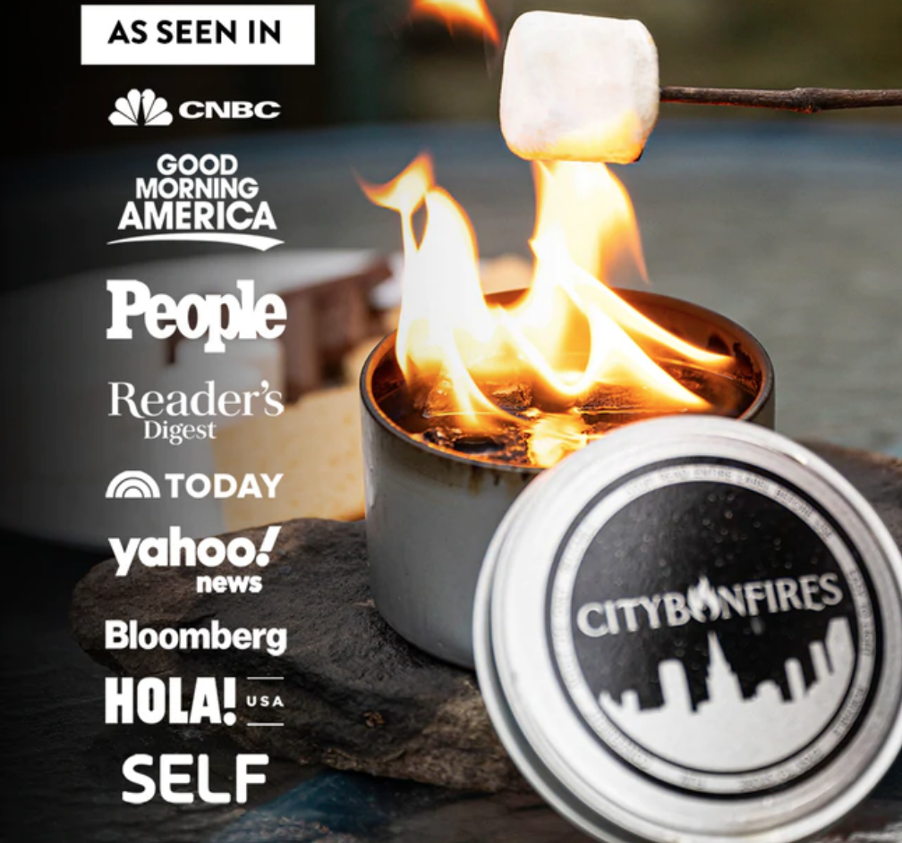 City bonfire product with marshmallow over flames, featuring media outlets logos.