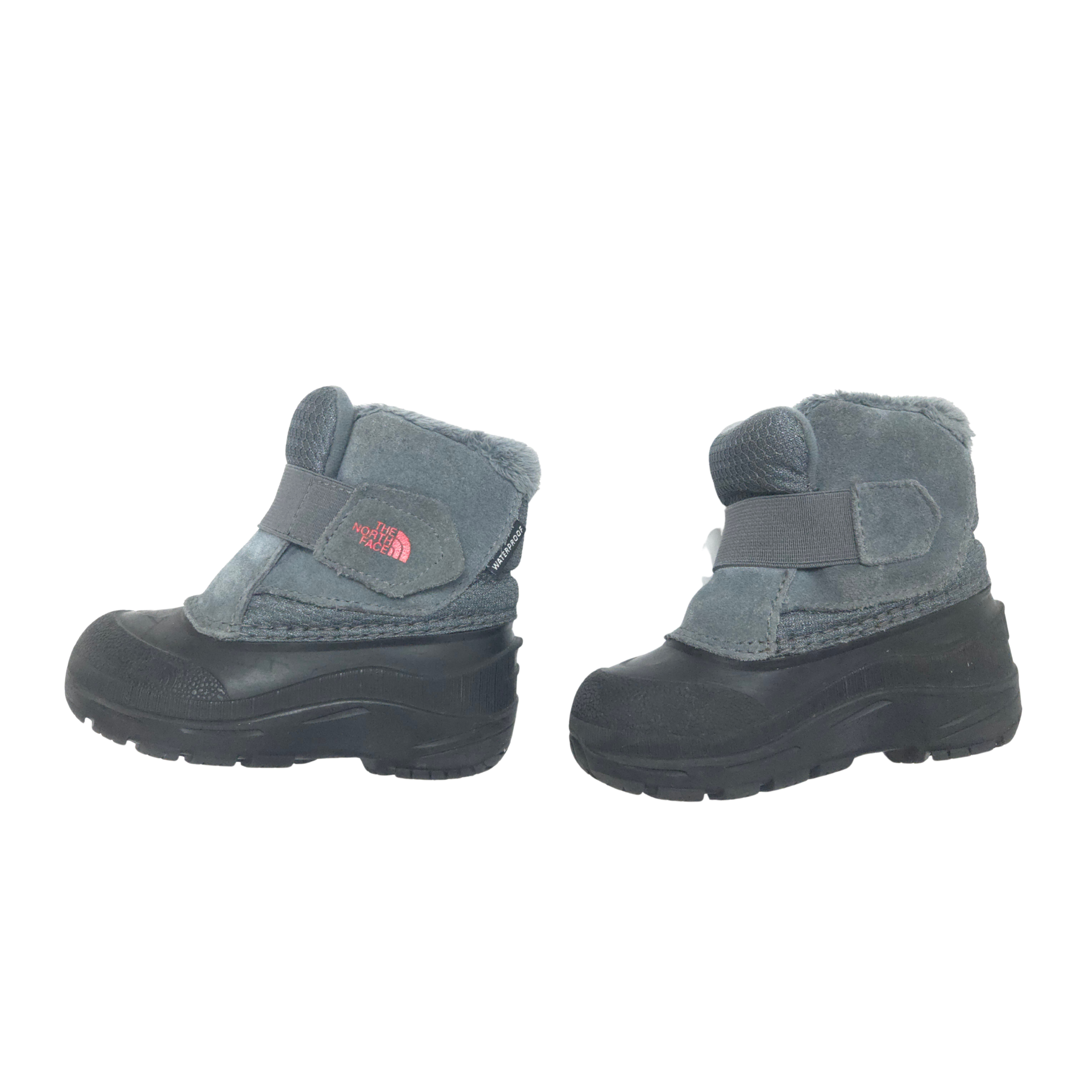 Pair of children's winter boots with gray suede upper and black rubber sole on a white background.