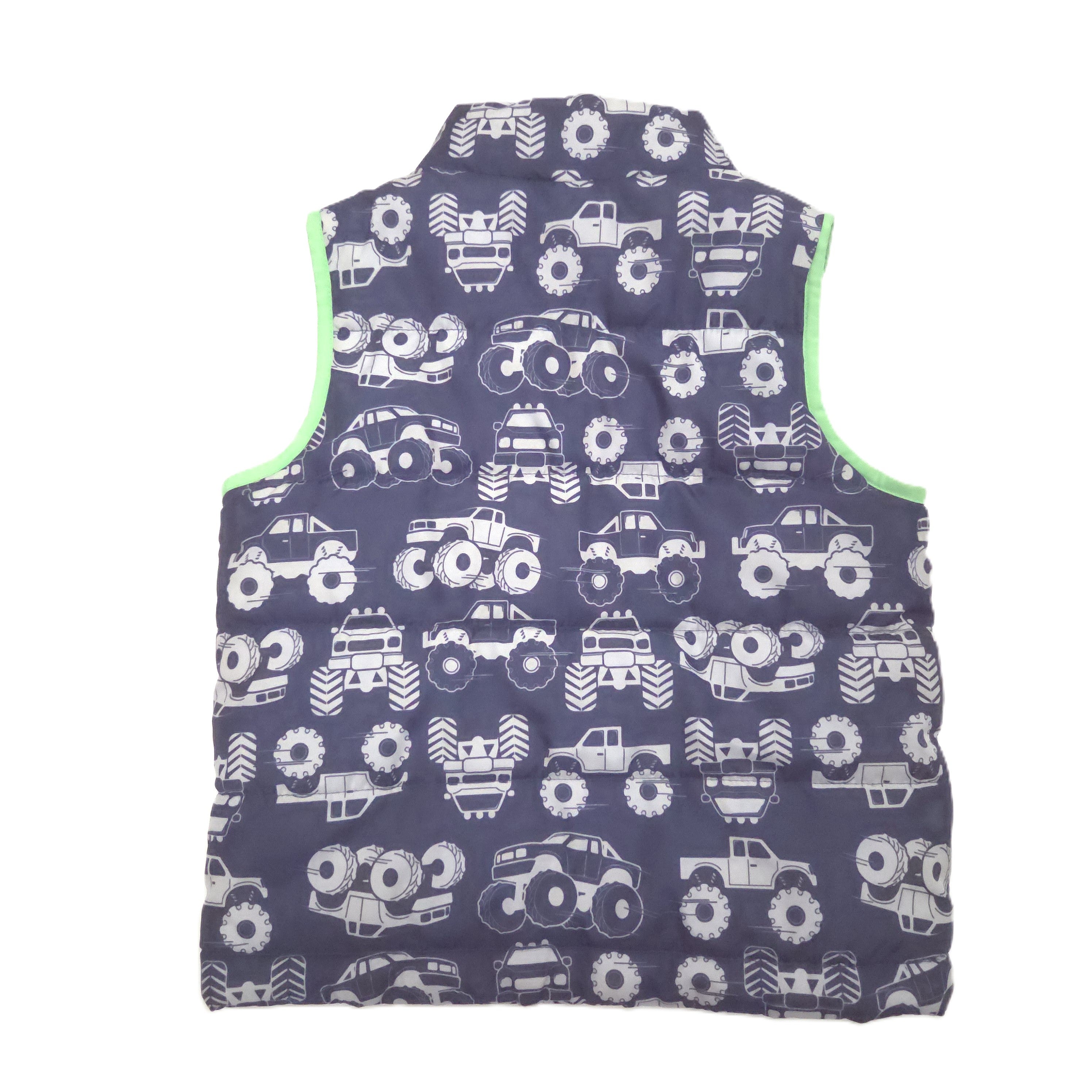 A sleeveless quilted vest with a dark blue background covered in a white monster truck, featuring bright lime green trim along the inner edges.