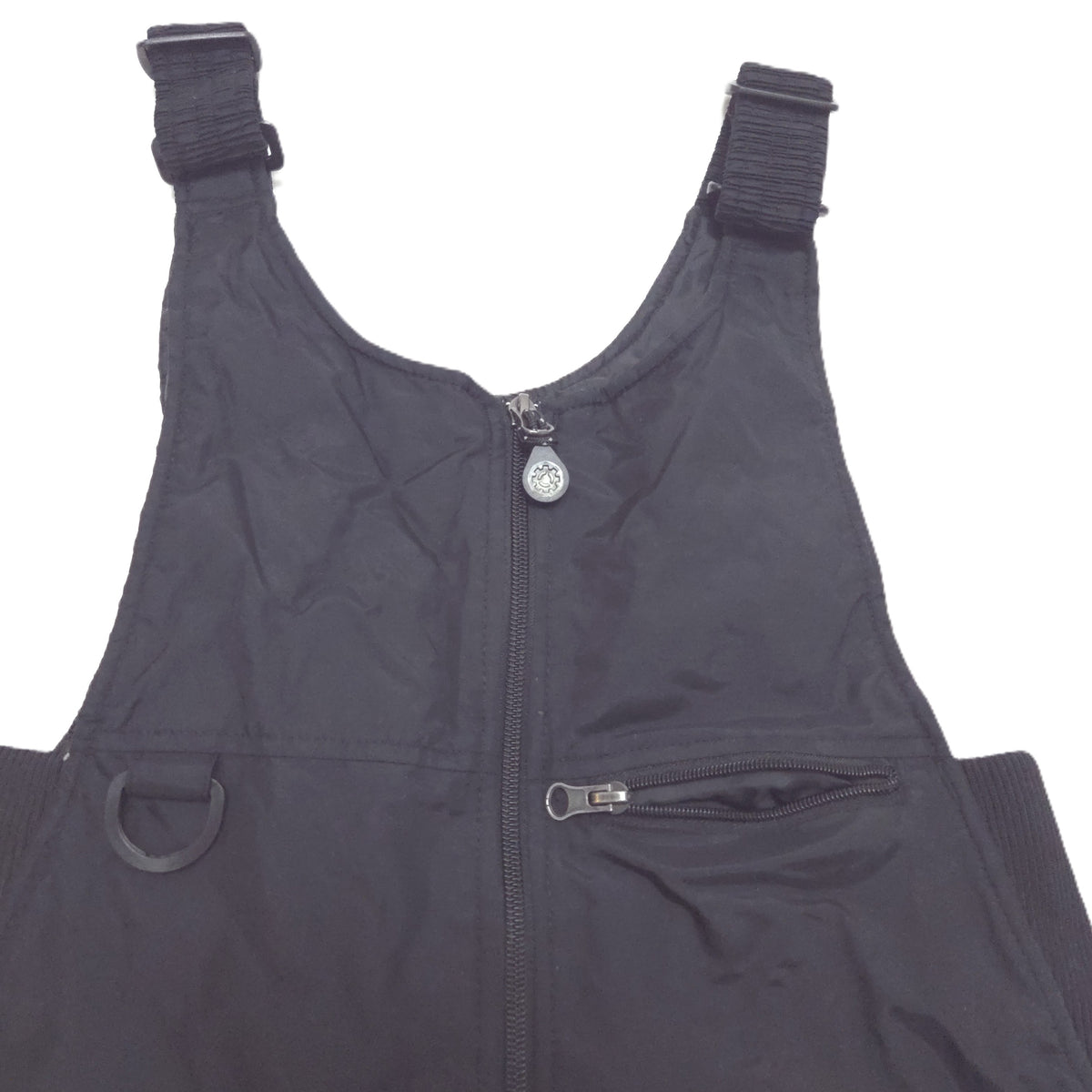 Black insulated bib snowpants showing detail of packet and hook.