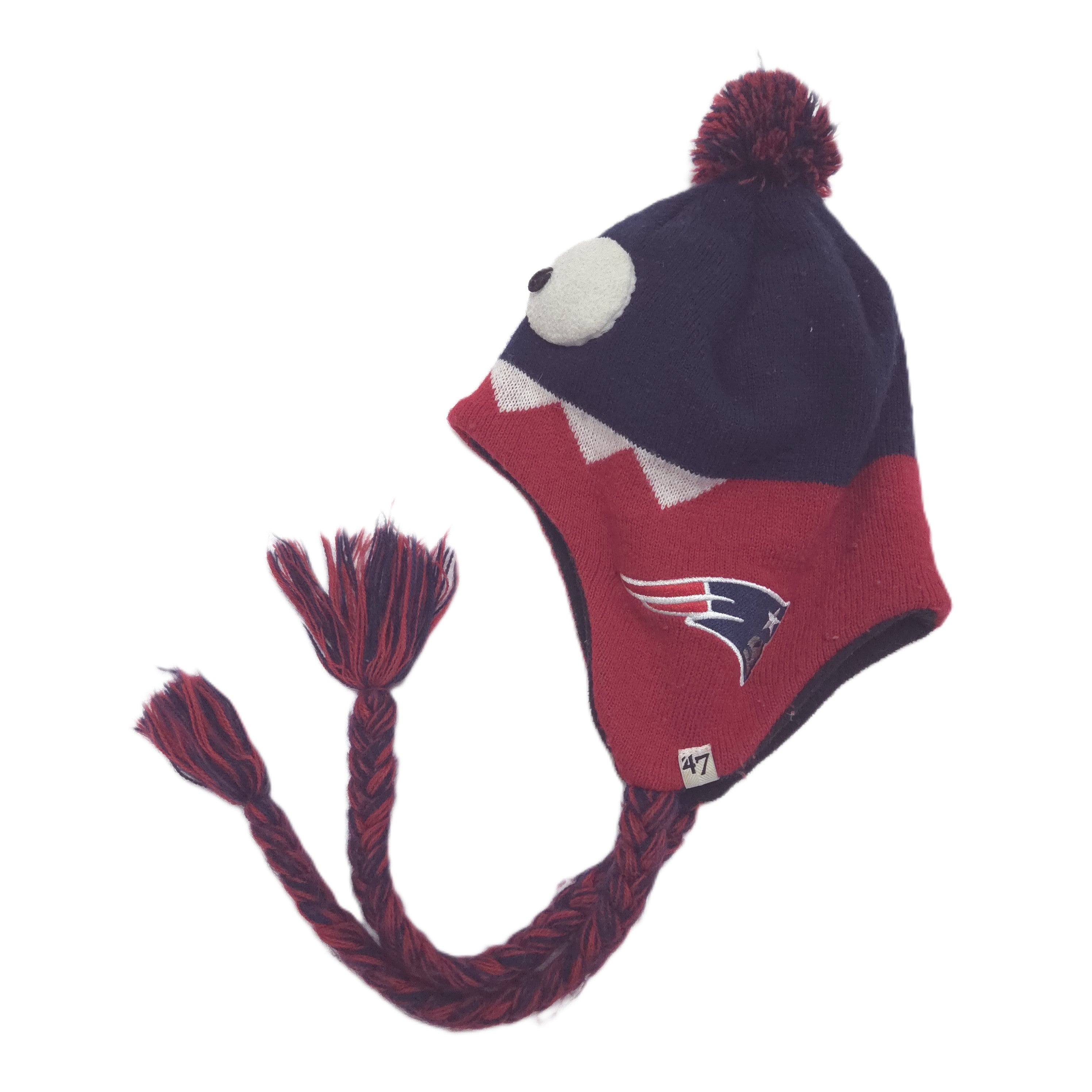 A New England Patriots themed knit pom-pom hat with ear flaps, featuring a navy blue top, red lower section, white eye detail, and a braided pom-pom ear cord. The Patriots logo is visible on the flap.