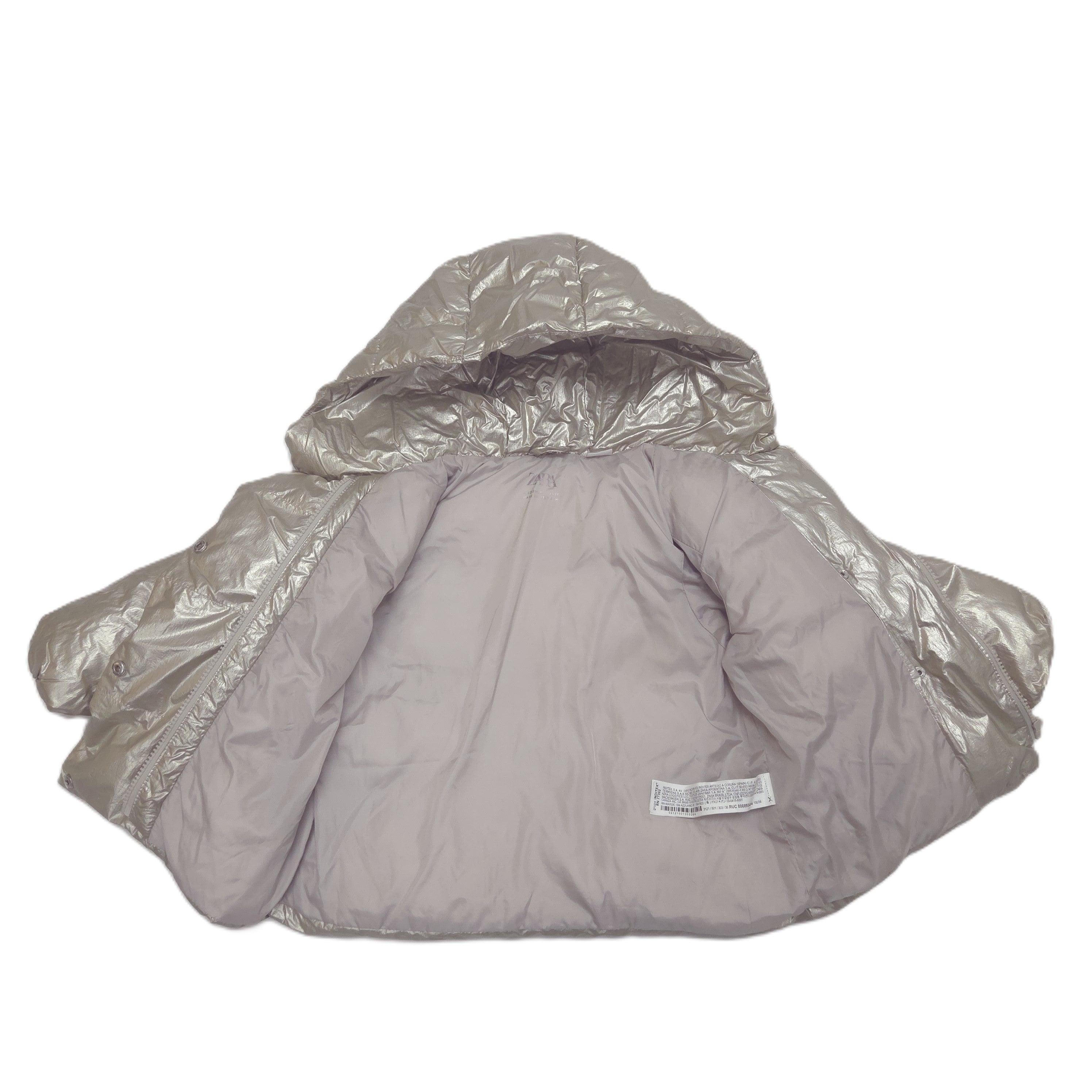 A puffer jacket with a shiny metallic gold hood and shoulders, shown open