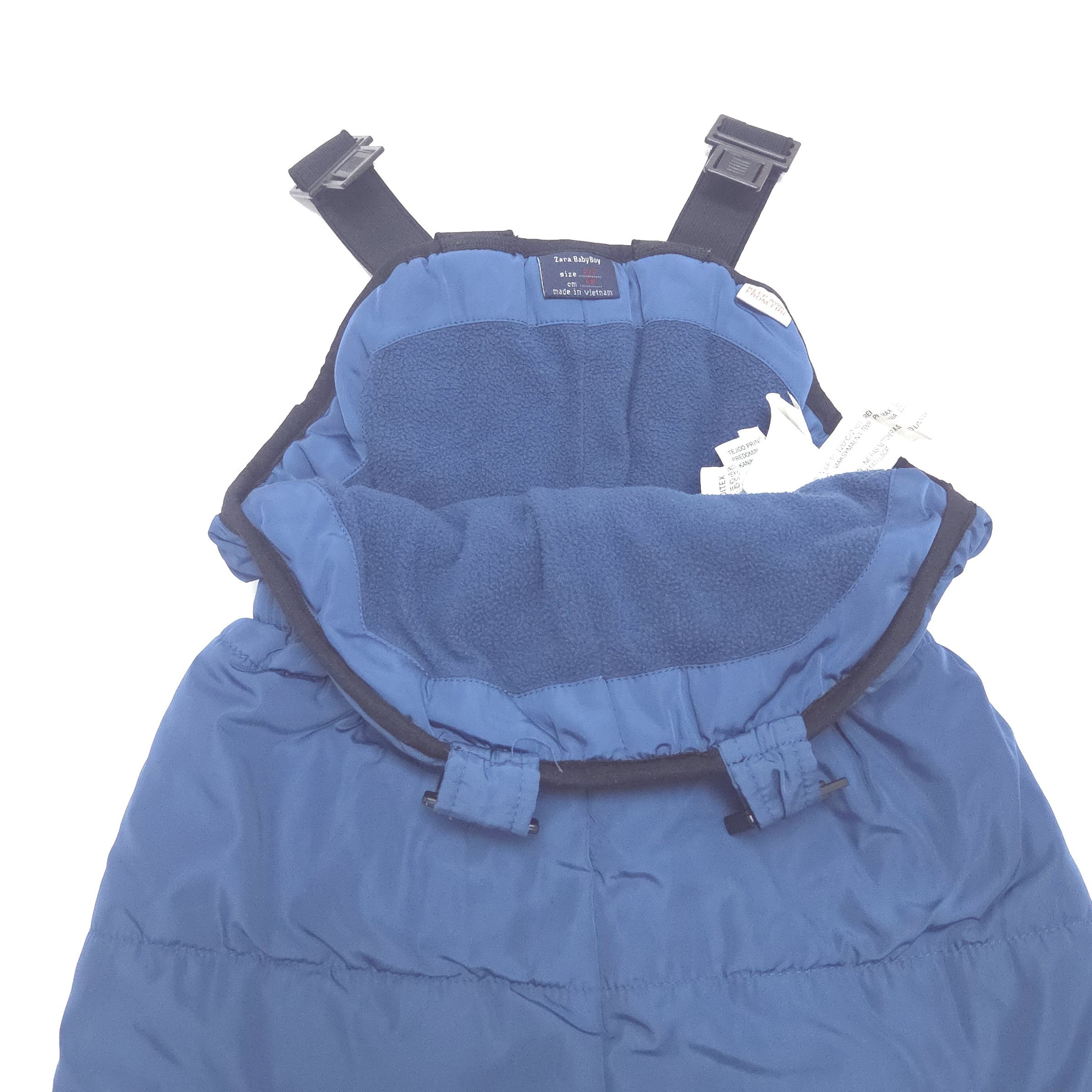A blue baby snowpants with a plush fleece-lining and black adjustable straps with plastic buckles, shown against a plain white background.