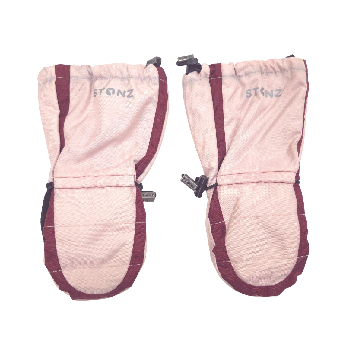 A pair of Stonz swinter mittens shown flat against a white background, featuring a light pink body with dark burgundy side panels and black adjustable straps.