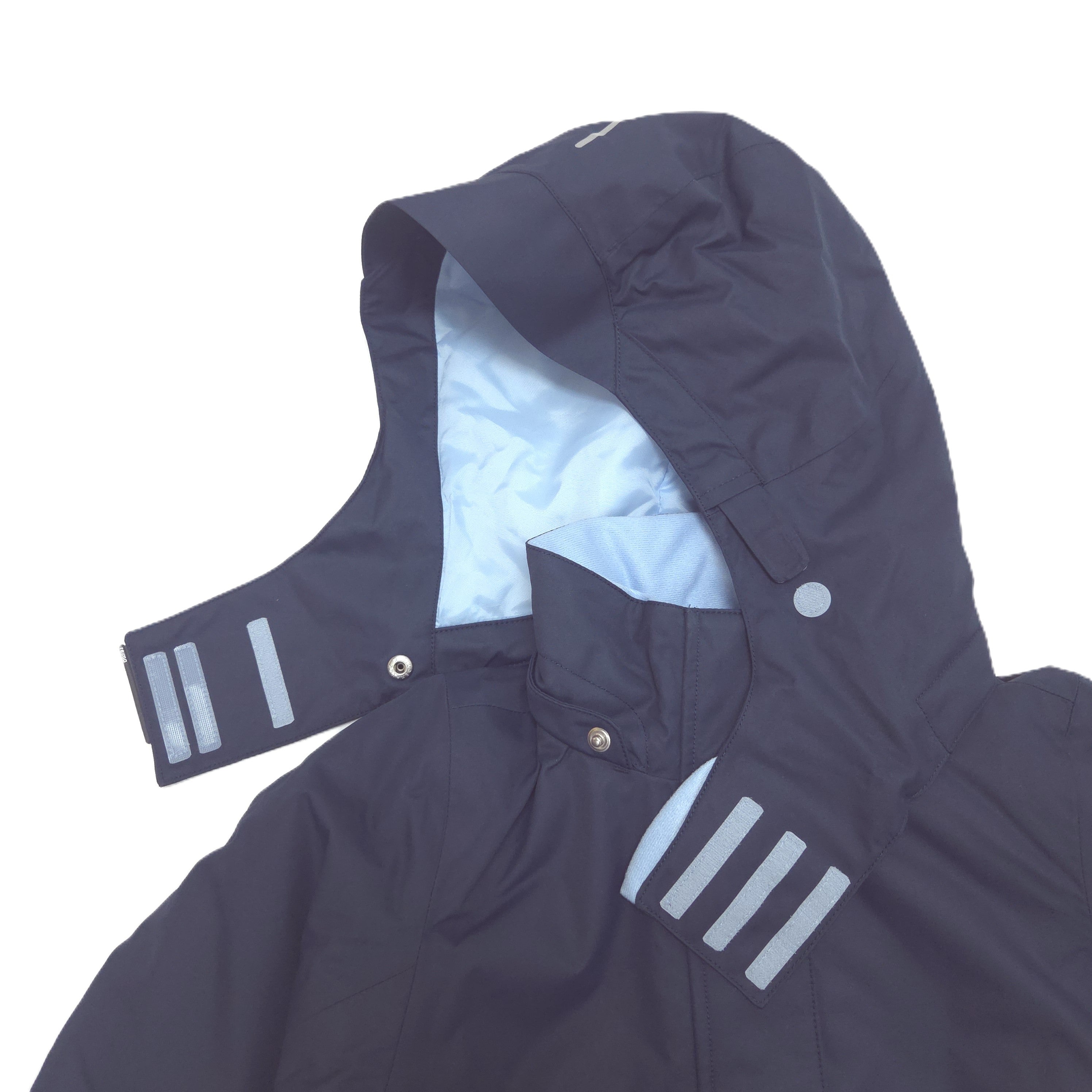 A close-up of a dark navy hooded rain jacket with reflective silver stripes on the sleeve and chest, and a light blue interior lining.