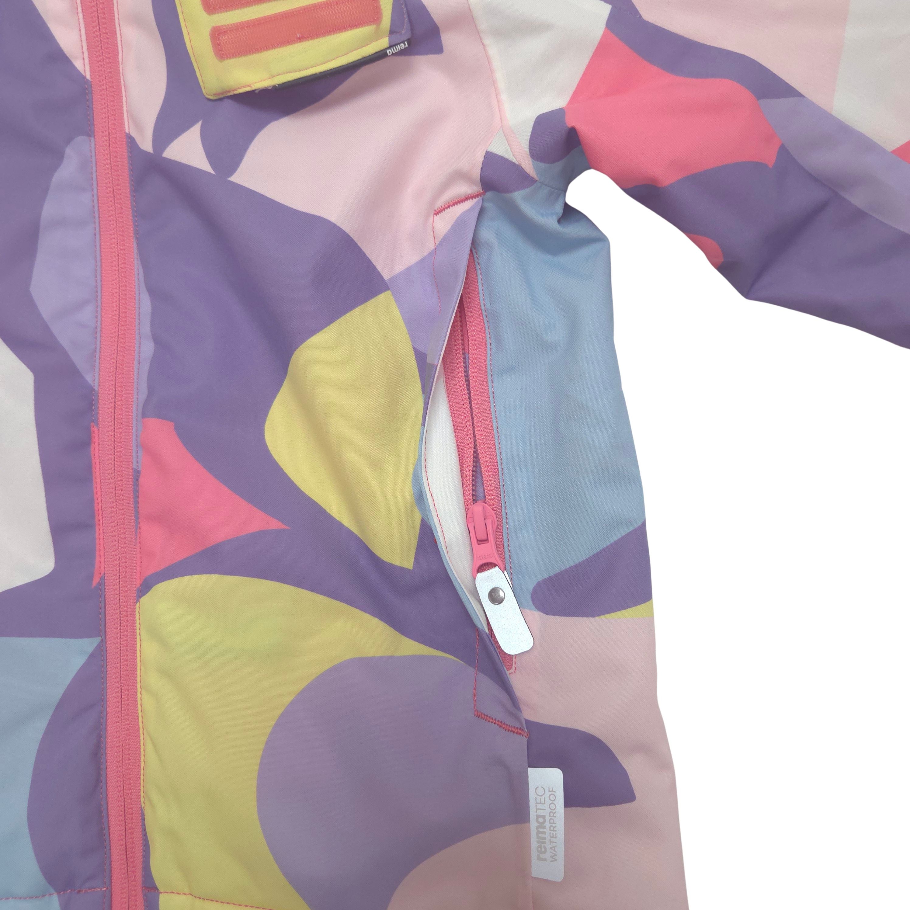 Close-up of a children's jacket with a pastel abstract pattern in pink, purple, yellow, and light blue, featuring a pink zipper and a white zipper pull.