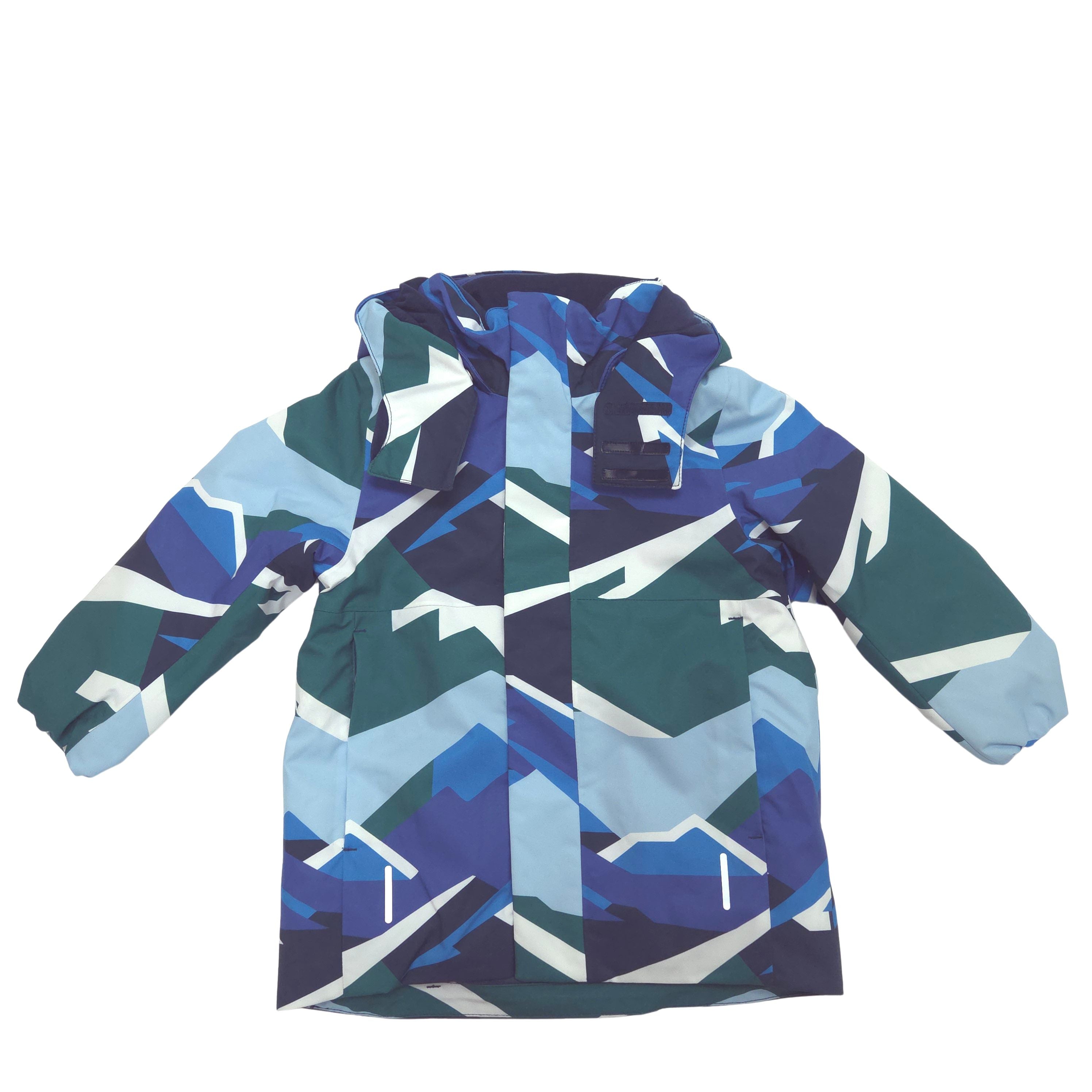 A hooded children's jacket featuring a geometric mountain pattern in shades of blue, navy, green, and white, laid flat against a white background.