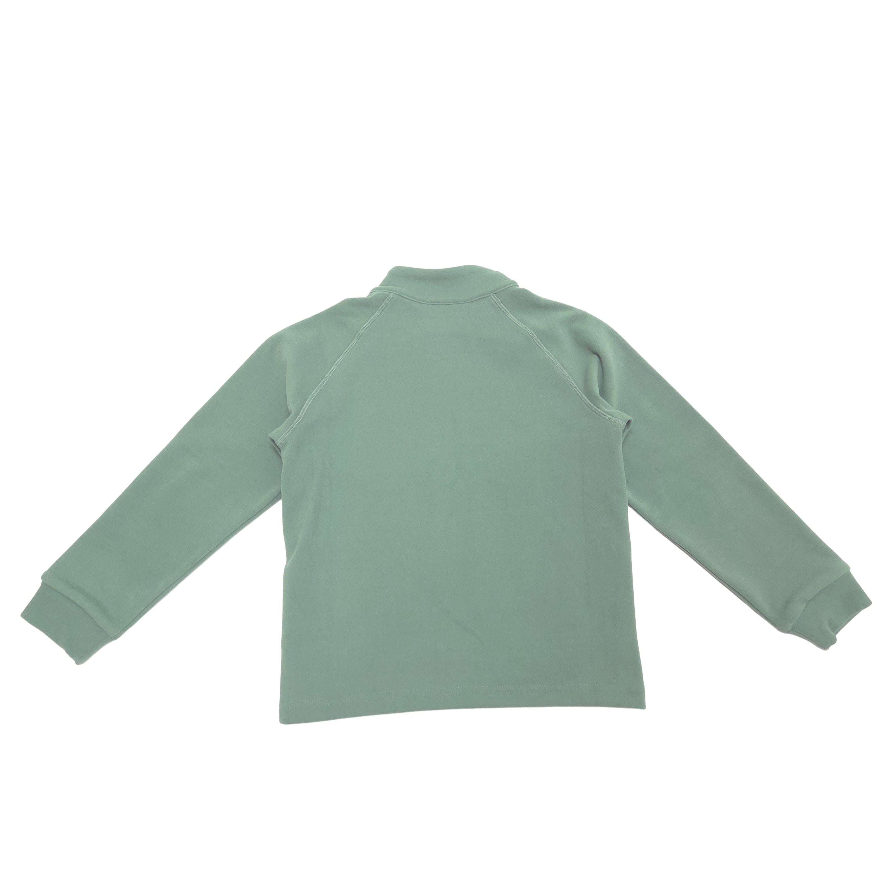 A sage green long-sleeve raglan turtleneck top shown from the back, laid flat against a solid white background.