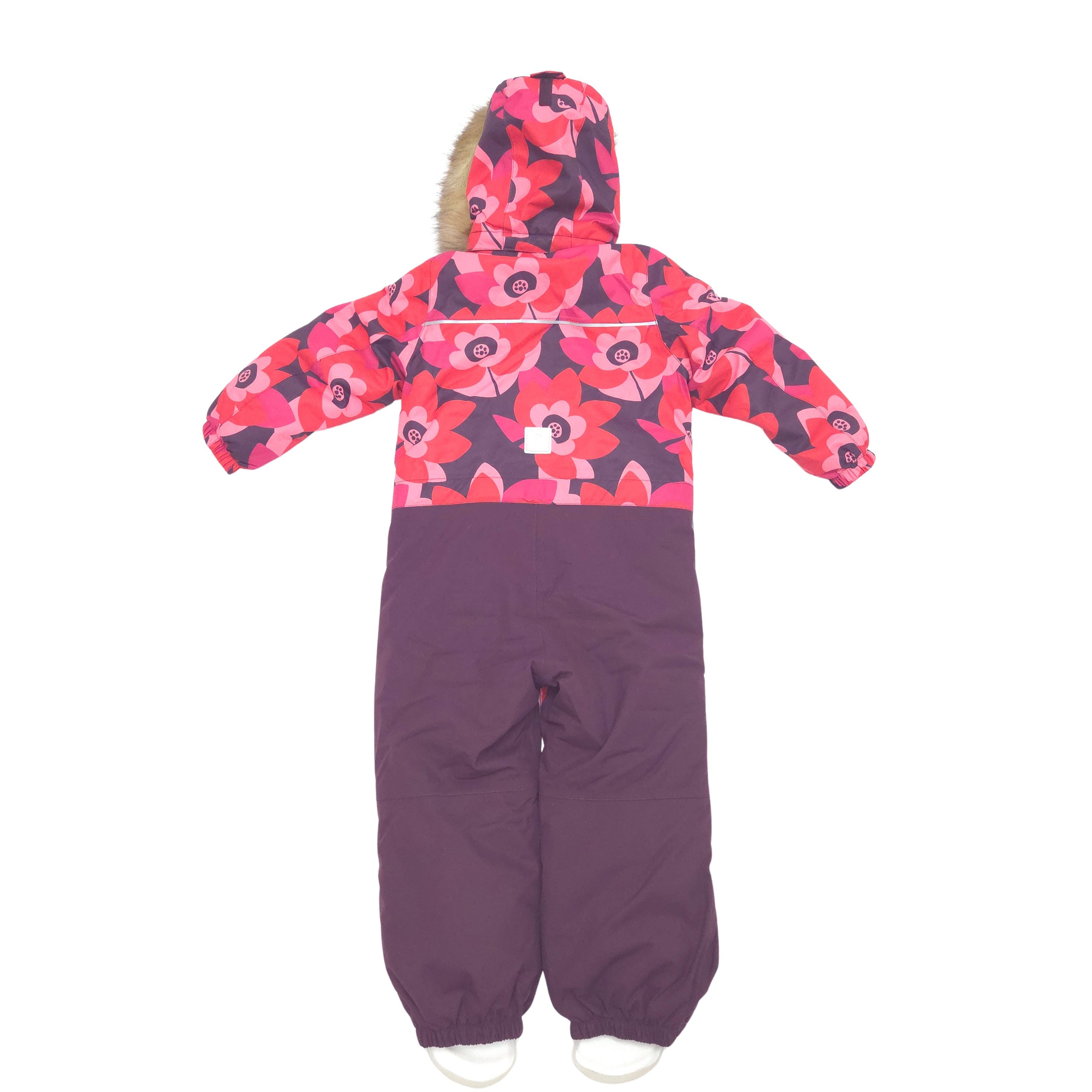 A children's hooded snowsuit shown from the back on a white background. The upper portion has a bold floral pattern in pink, red, and dark purple, while the lower legs are a solid dark purple.