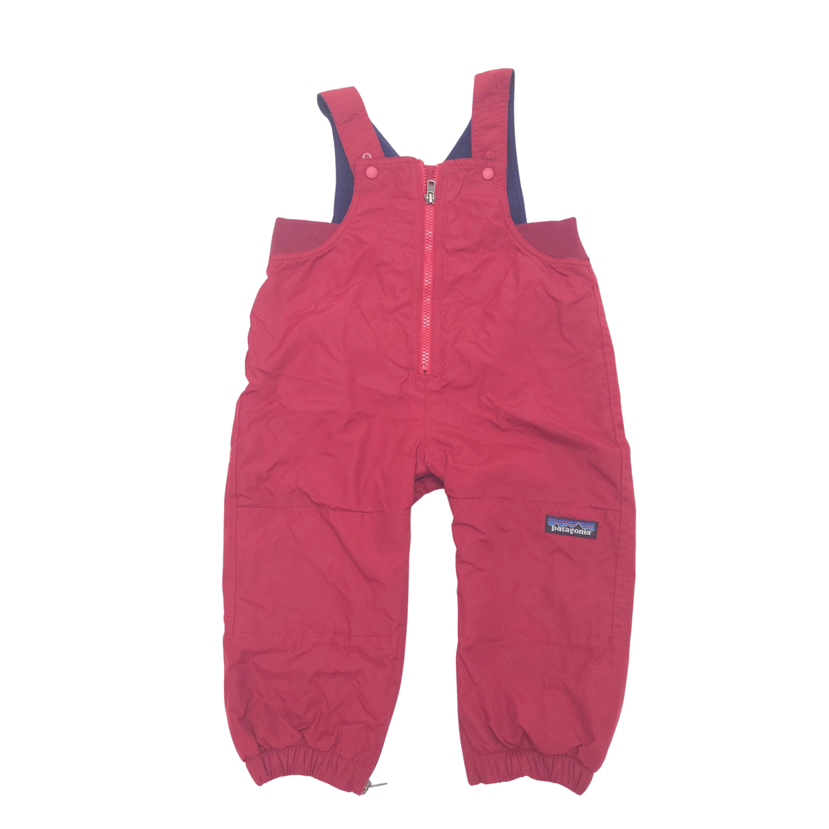 A pair of Patagonia children's snow pants in a red color, featuring a half-zip front, adjustable shoulder straps, and elastic cuffs, shown against a plain white background.