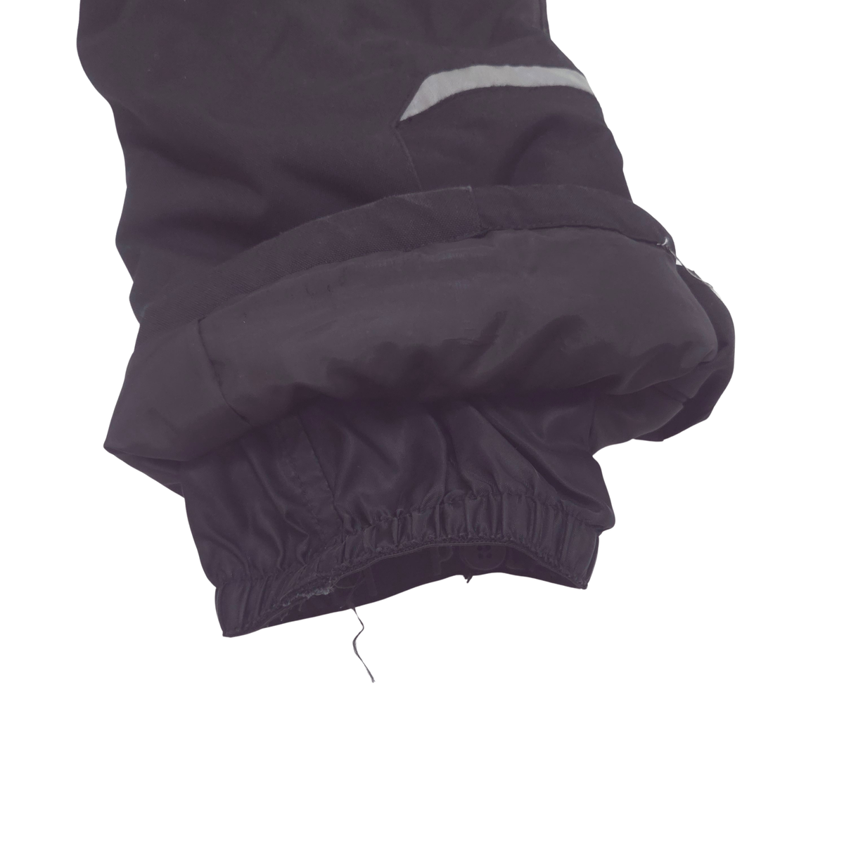 Internal gaiters at cuffs keep out snow; external scuff guards protect from boot- and ski-edge wear.