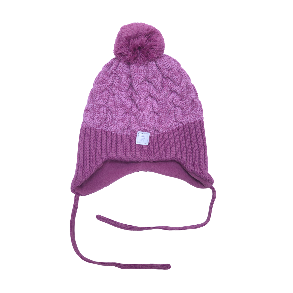 A purple cable-knit beanie hat with a matching pom-pom on top, a ribbed brim, and ear flaps with long ties, shown against a plain white background.