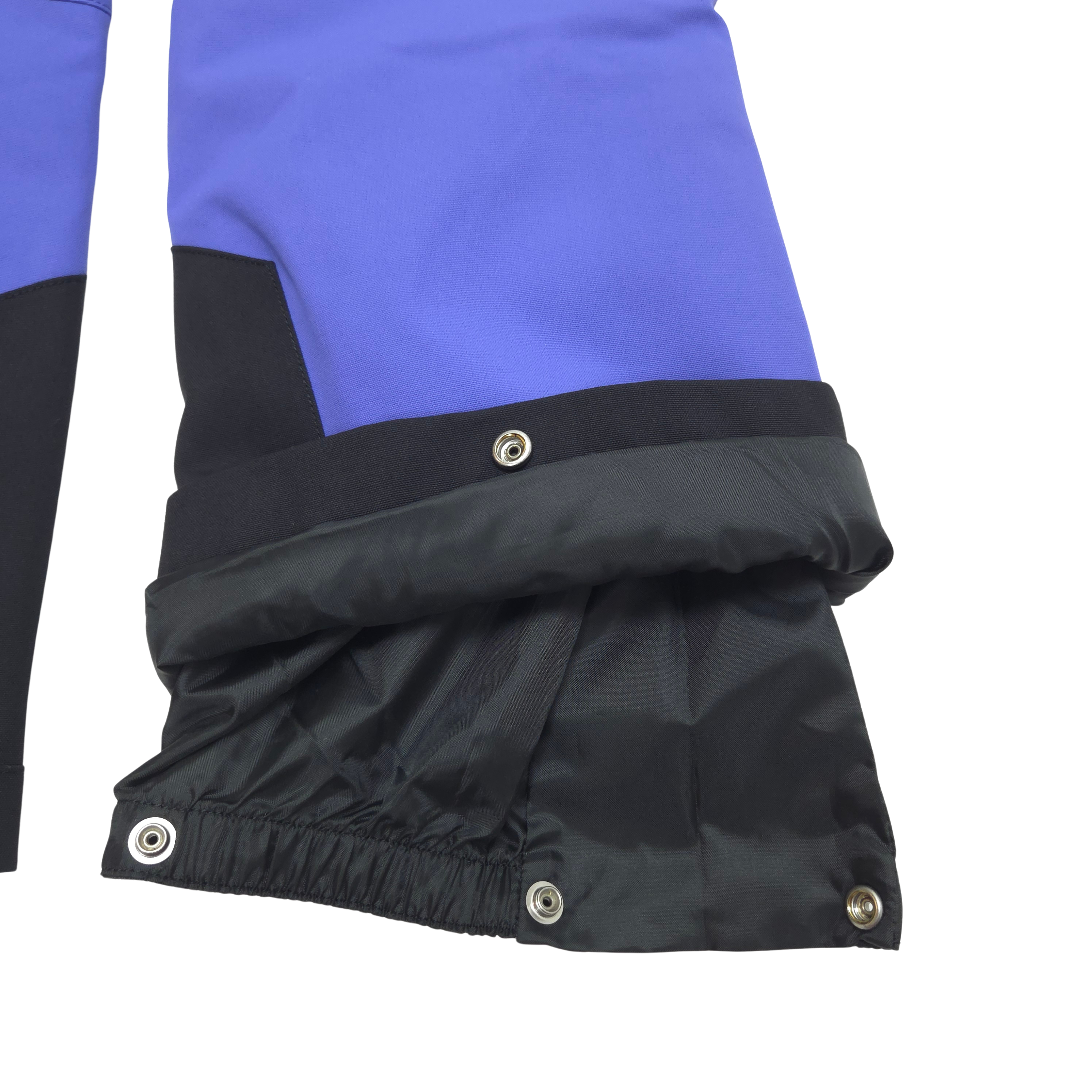 Internal gaiters at cuffs keep out snow; external scuff guards protect from boot- and ski-edge wear