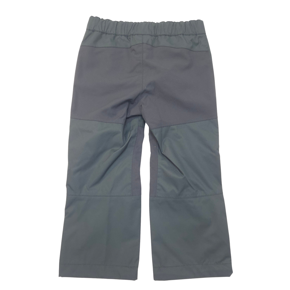A pair of black color block pants laid flat against a white background.