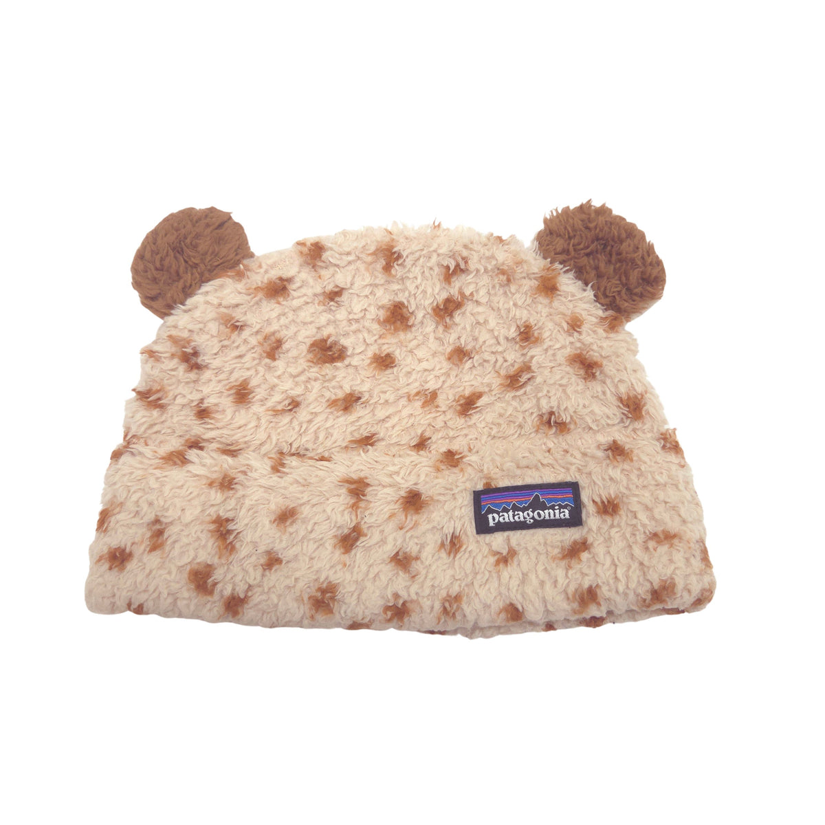 A beige Patagonia fleece beanie with brown faux-fur spots and two brown bear ears on top, featuring the Patagonia logo patch on the front.