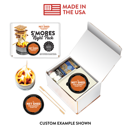 Net Shed S'mores Night Pack kit shown with its open white box, a printed package insert, a small flame candle, a round tin, wooden sticks, and a 'Made in the USA' badge on a white background.