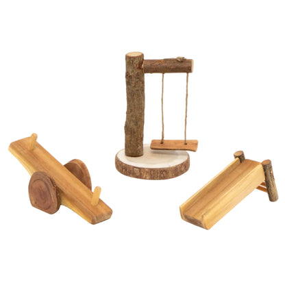 Three small natural wood toy structures on a white background: a seesaw, a swing set, and a small slide.