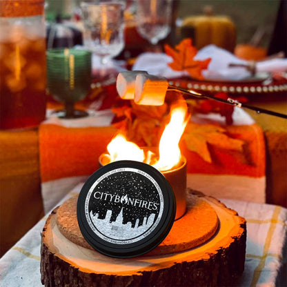 City Bonfires product on a wooden stump with a fire and marshmallow, set against a festive table.