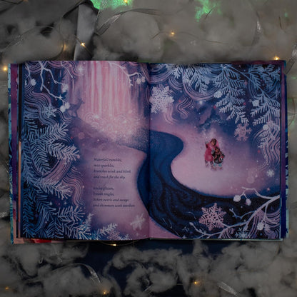 Illustrated book open to a snowy landscape with two characters, surrounded by decorative lights and ribbons.