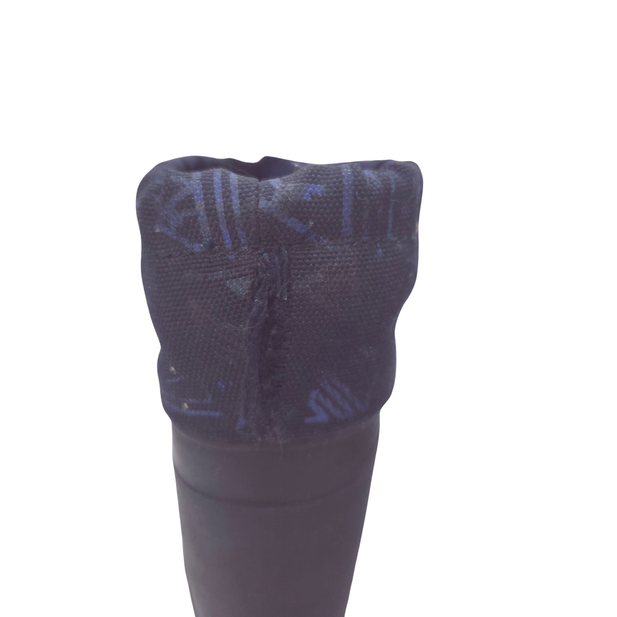 Close-up of the top opening of a navy boot, showing a textured fabric cuff with a subtle blue geometric pattern with hole.