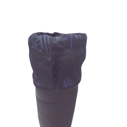 Close-up of the top opening of a navy boot, showing a textured fabric cuff with a subtle blue geometric pattern with hole.