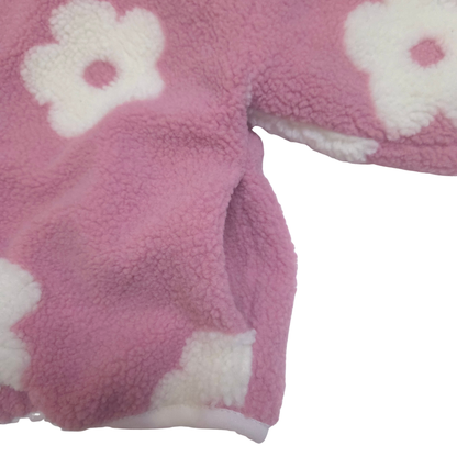 Close-up of pink fleece fabric with white flower patterns