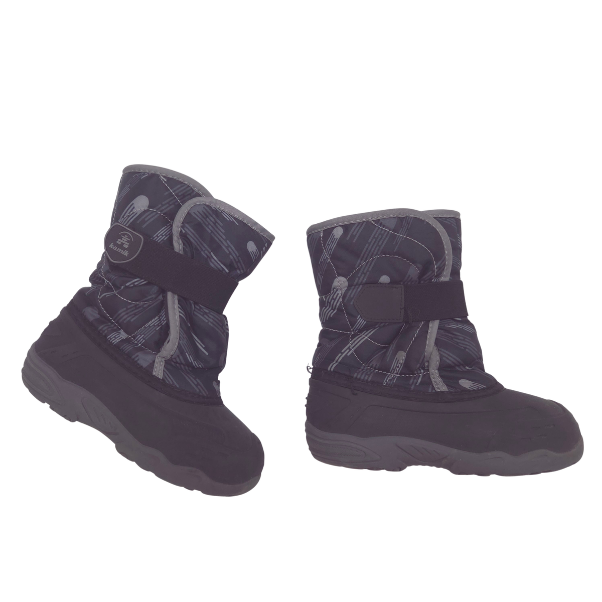 A pair of winter boots in a dark gray and black camouflage pattern with gray laces and black soles, shown against a plain white background.