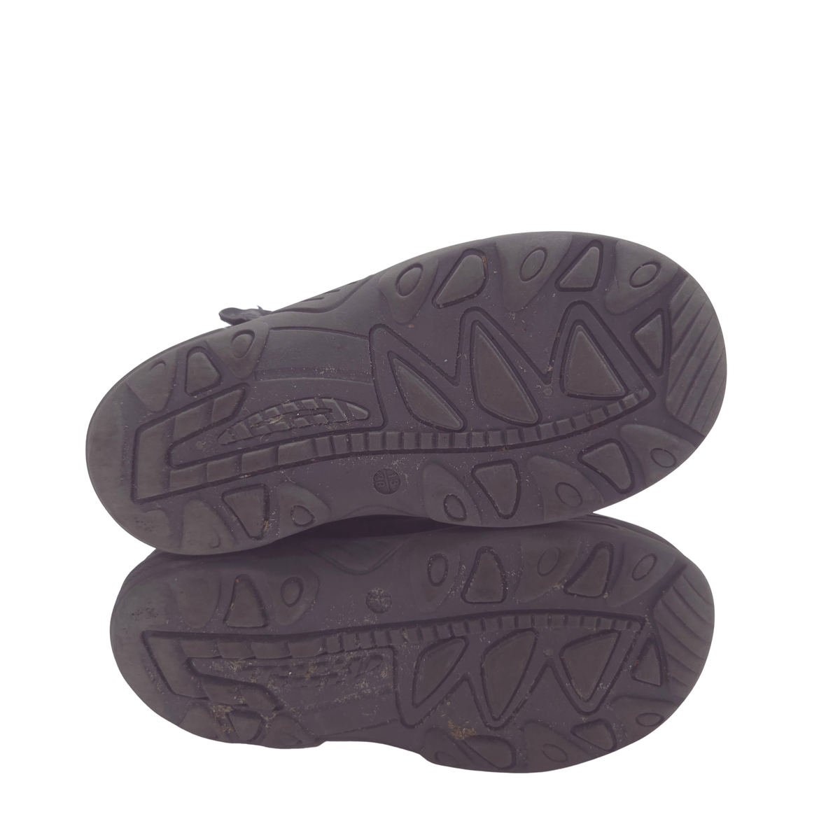The outsole of a black shoe, showing the tread pattern, photographed from a top-down view on a white background.