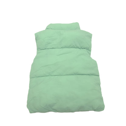 A mint green puffer vest back image