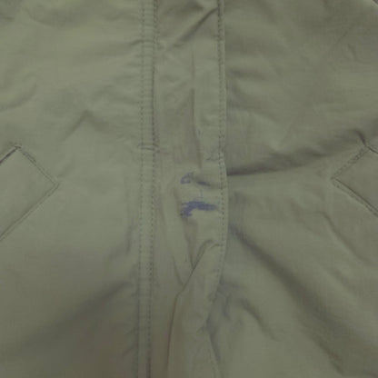 An olive green hooded puffer jacket stains