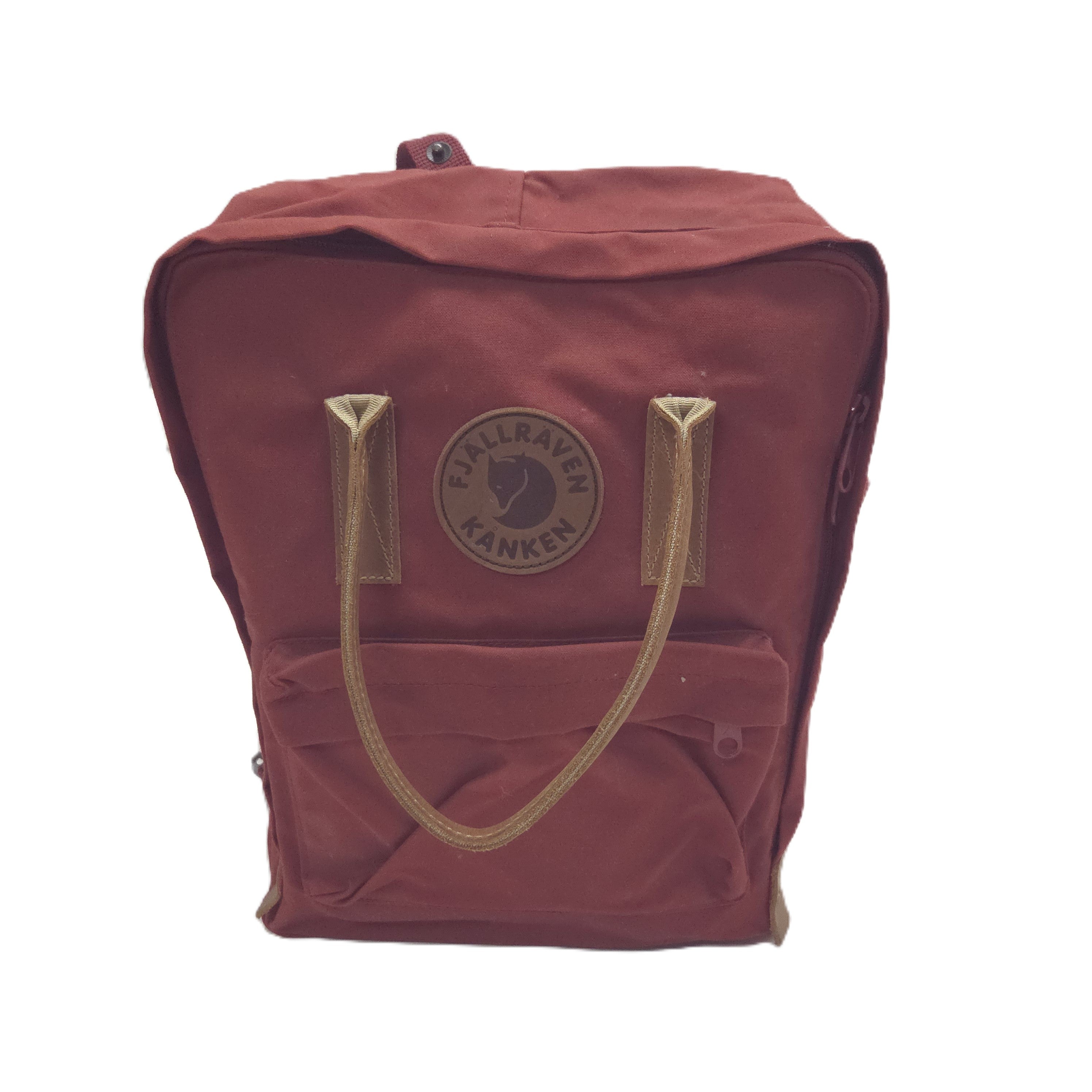 A Fjäl Raven Kanken backpack in a muted reddish-brown color with tan webbing handles and a circular logo patch on the front, shown against a plain white background.