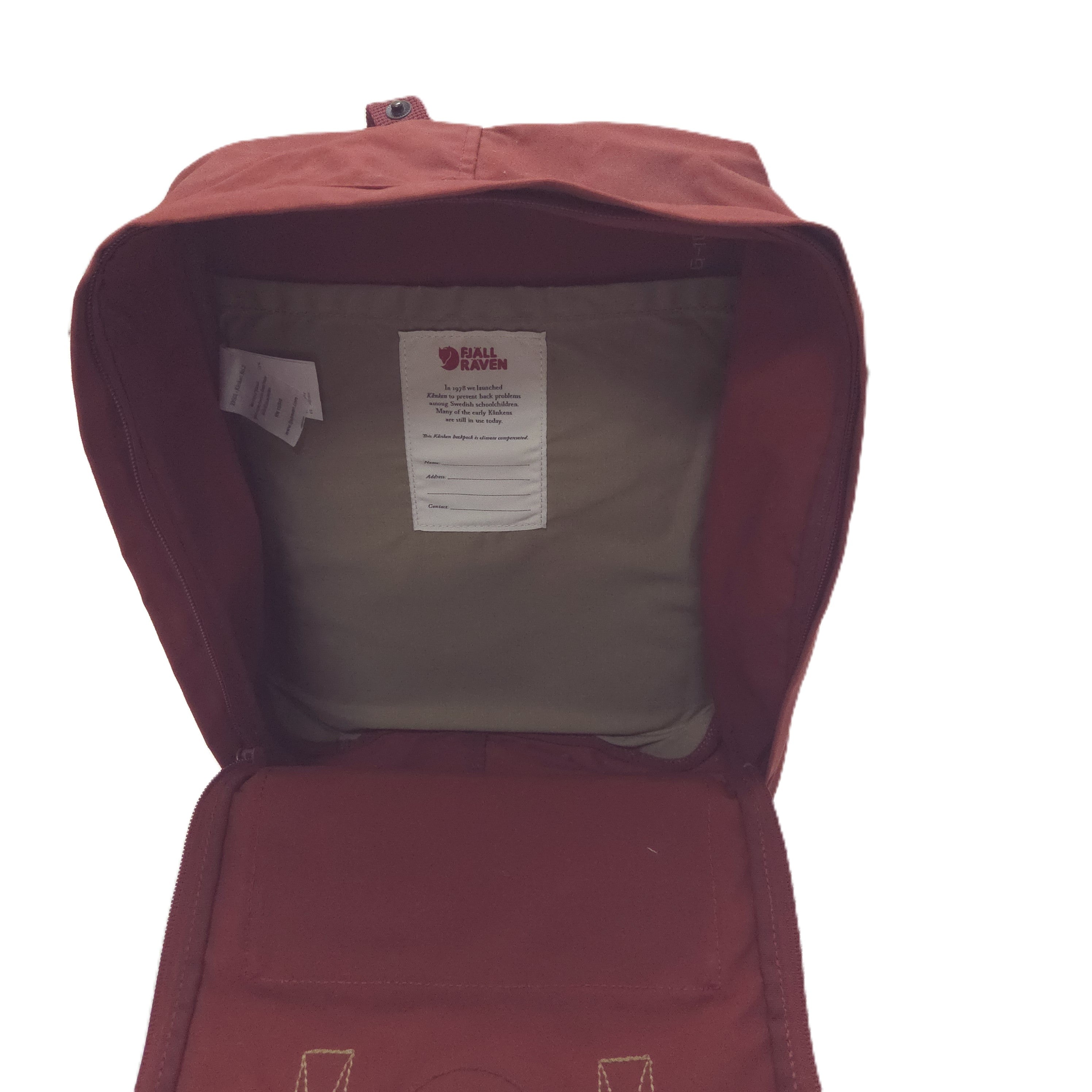 An open burgundy Fjälkar backpack showing the interior lining and a white brand label inside the main compartment, set against a plain white background.