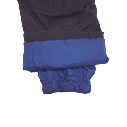 Close-up of folded pants showing a cuff with an elastic gathered bottom, on a white background.