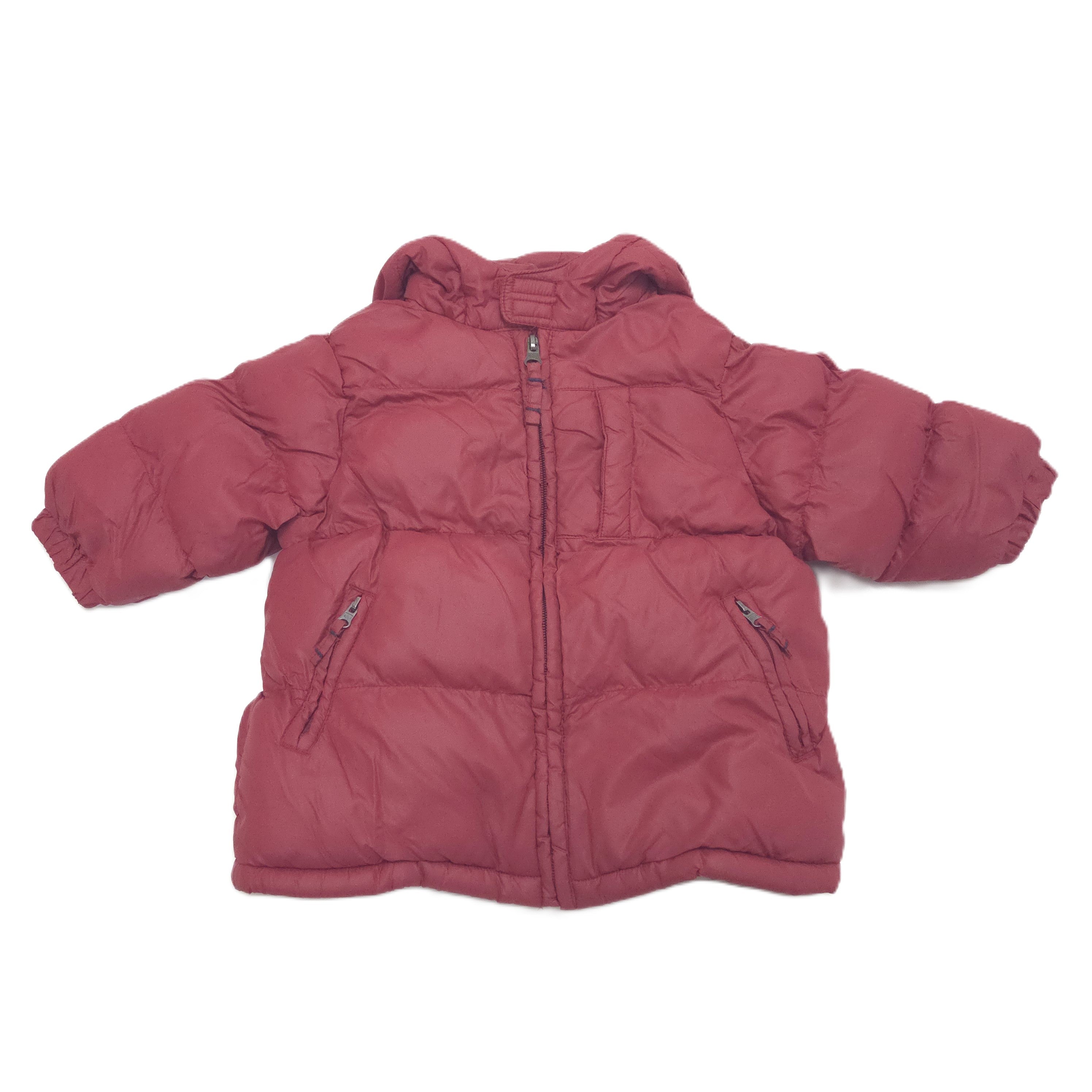 A red hooded puffer jacket shown from the front, laid flat against a solid white background.