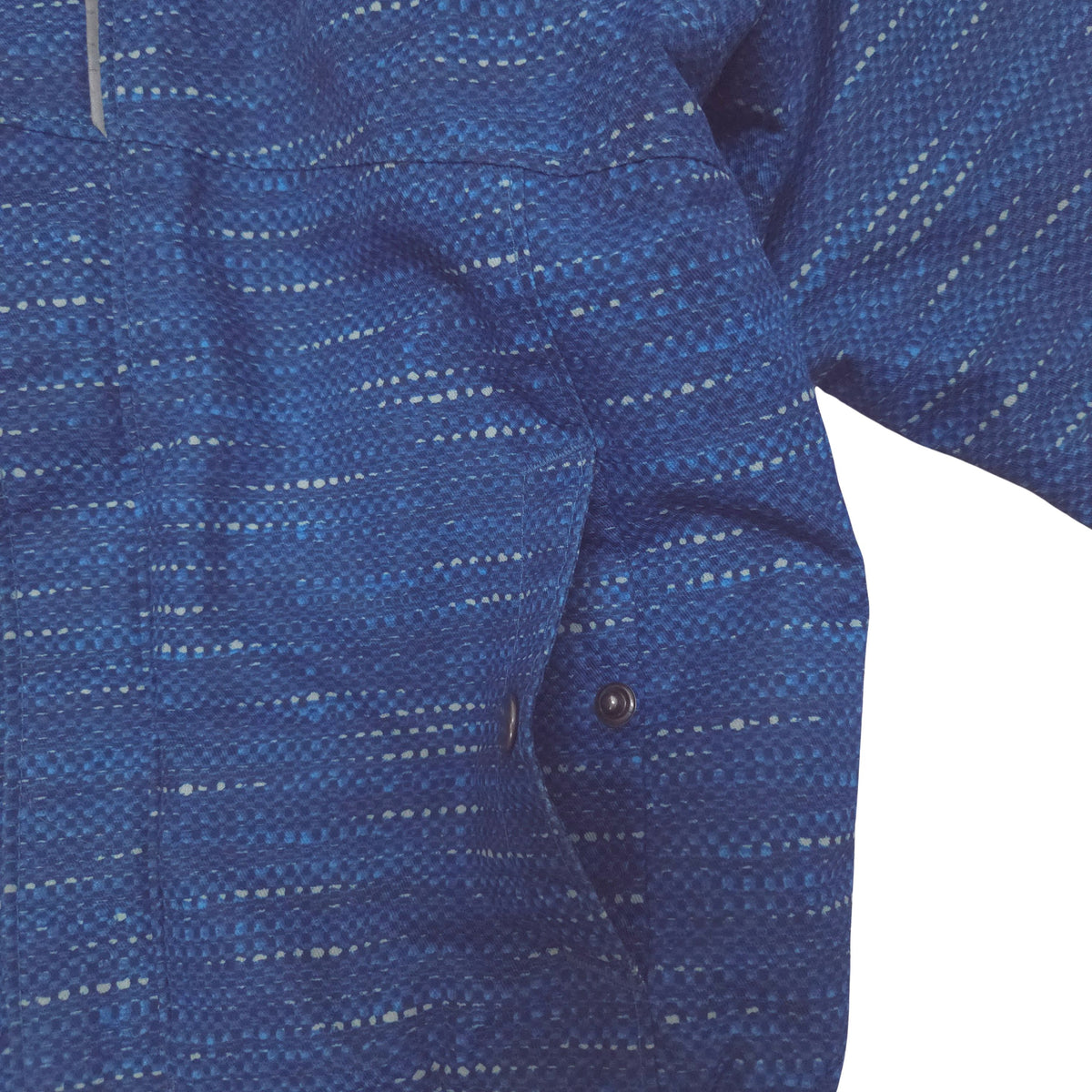 Close-up of a blue patterned fabric garment jacket with packet detail