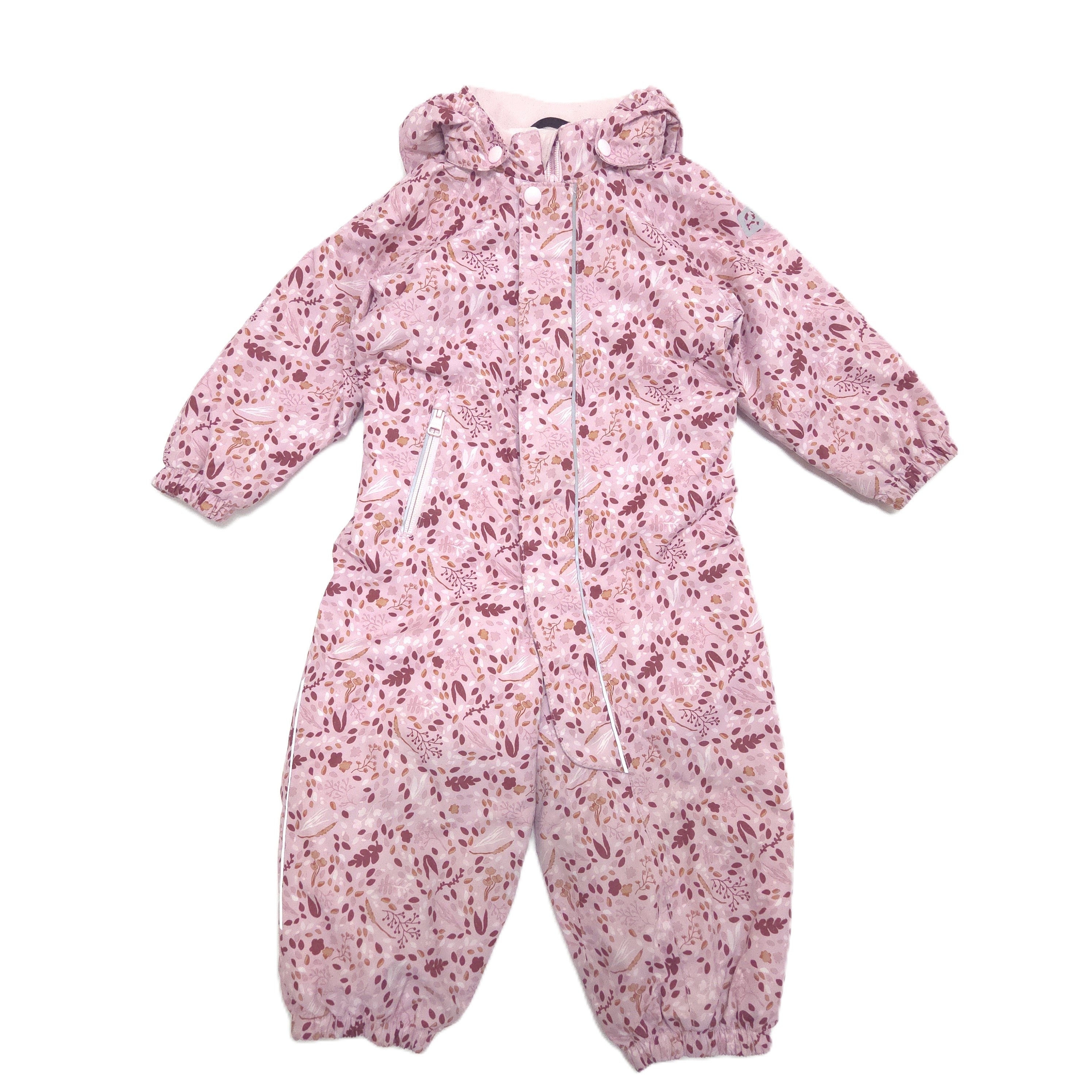 A pink hooded snowsuit with a dense floral and abstract print in shades of mauve, and white, laid flat against a white background.