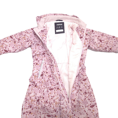A pink hooded winter snowsuit with a floral and abstract print, featuring a light pink quilted lining and a visible Reima brand label.