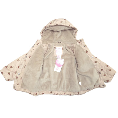 A beige hooded puffer jacket featuring a soft fleece interior and attached retail tags, shown against a plain white background.