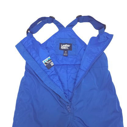 A blue snow bib pants with adjustable shoulder straps, laid flat against a white background open detail