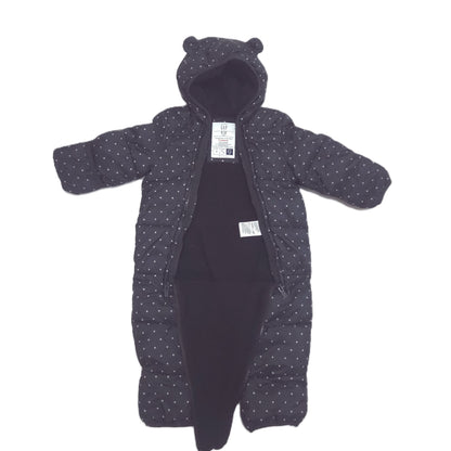 A black hooded snowsuit with a small white polka dot pattern, laid flat on a white background open detail