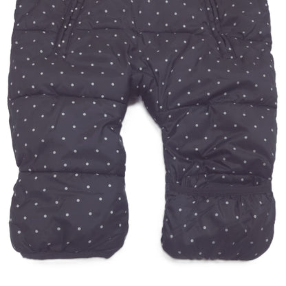 A black hooded snowsuit with a small white polka dot pattern fold-over booties