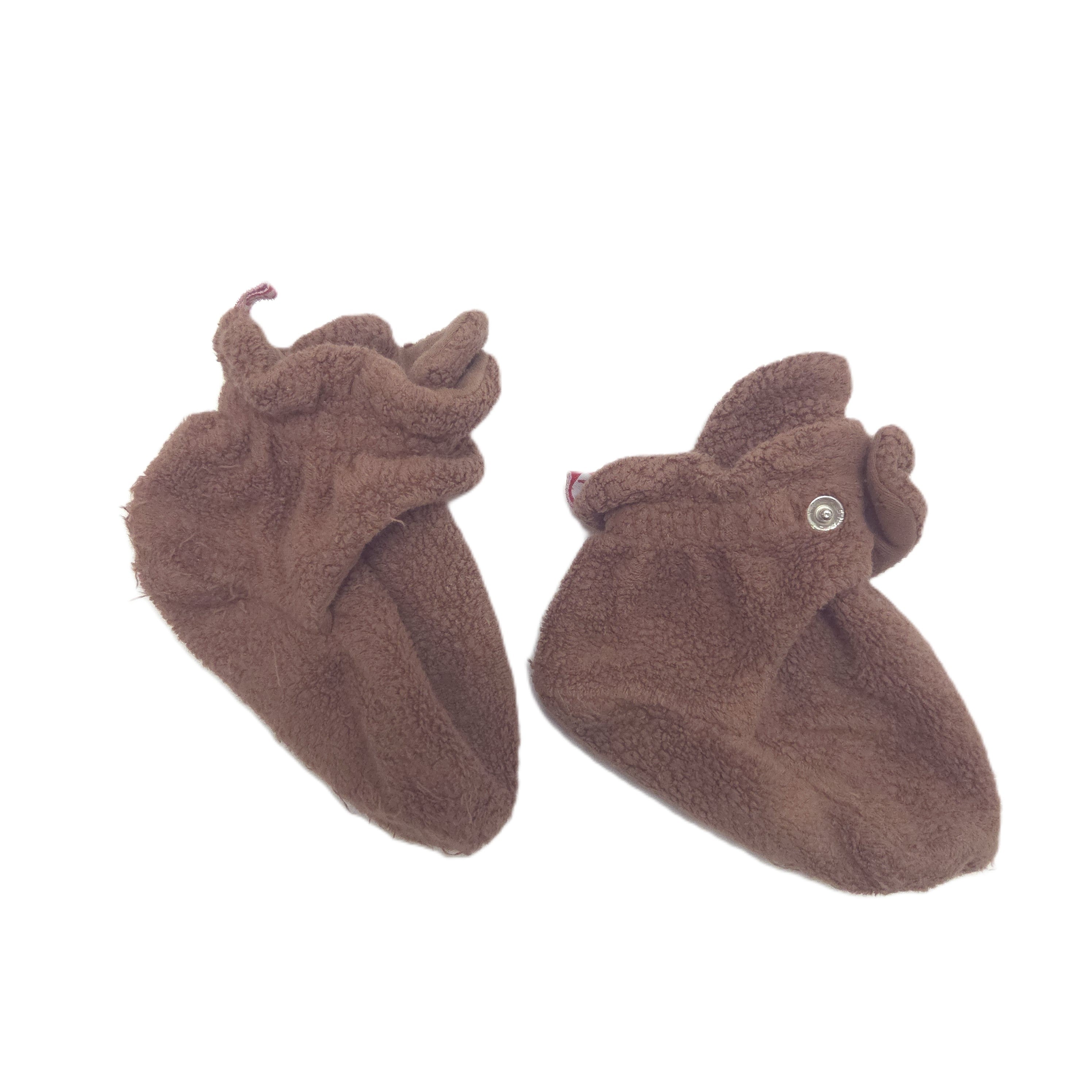 A pair of plush brown baby booties with snaps