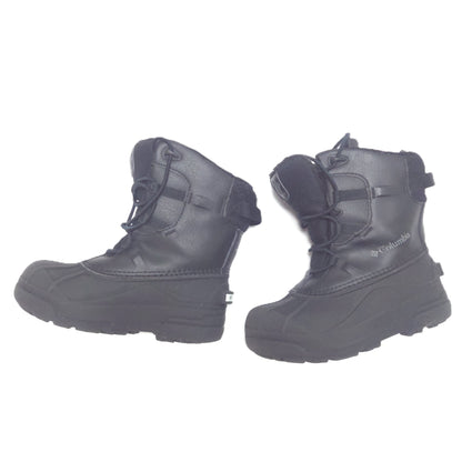 A pair of black Columbia winter boots with laces and hook-and-loop strap closures, shown from the side against a plain white background.