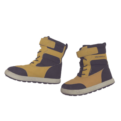 A pair of Merrell winter boots in mustard yellow and black, featuring hook-and-loop strap closures and thick off-white soles, shown against a plain white background.
