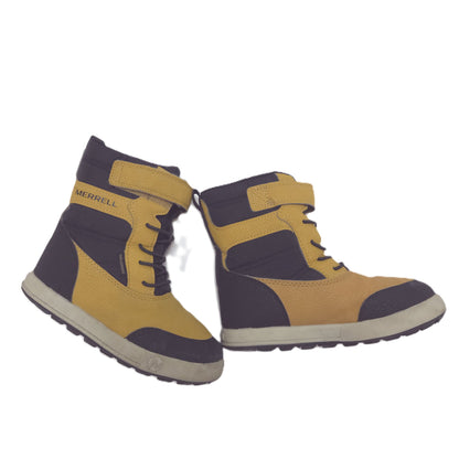 A pair of low-top Merrell boots in mustard yellow and black, featuring a hook-and-loop strap closure and a thick off-white sole.