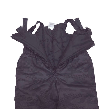 Black camouflage-patterned snow pants with adjustable shoulder straps, laid flat on a white background.