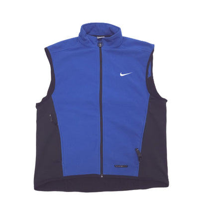 A Nike athletic vest in royal blue and black, featuring a full-length front zipper, a stand-up collar, and a white swoosh logo on the left chest.