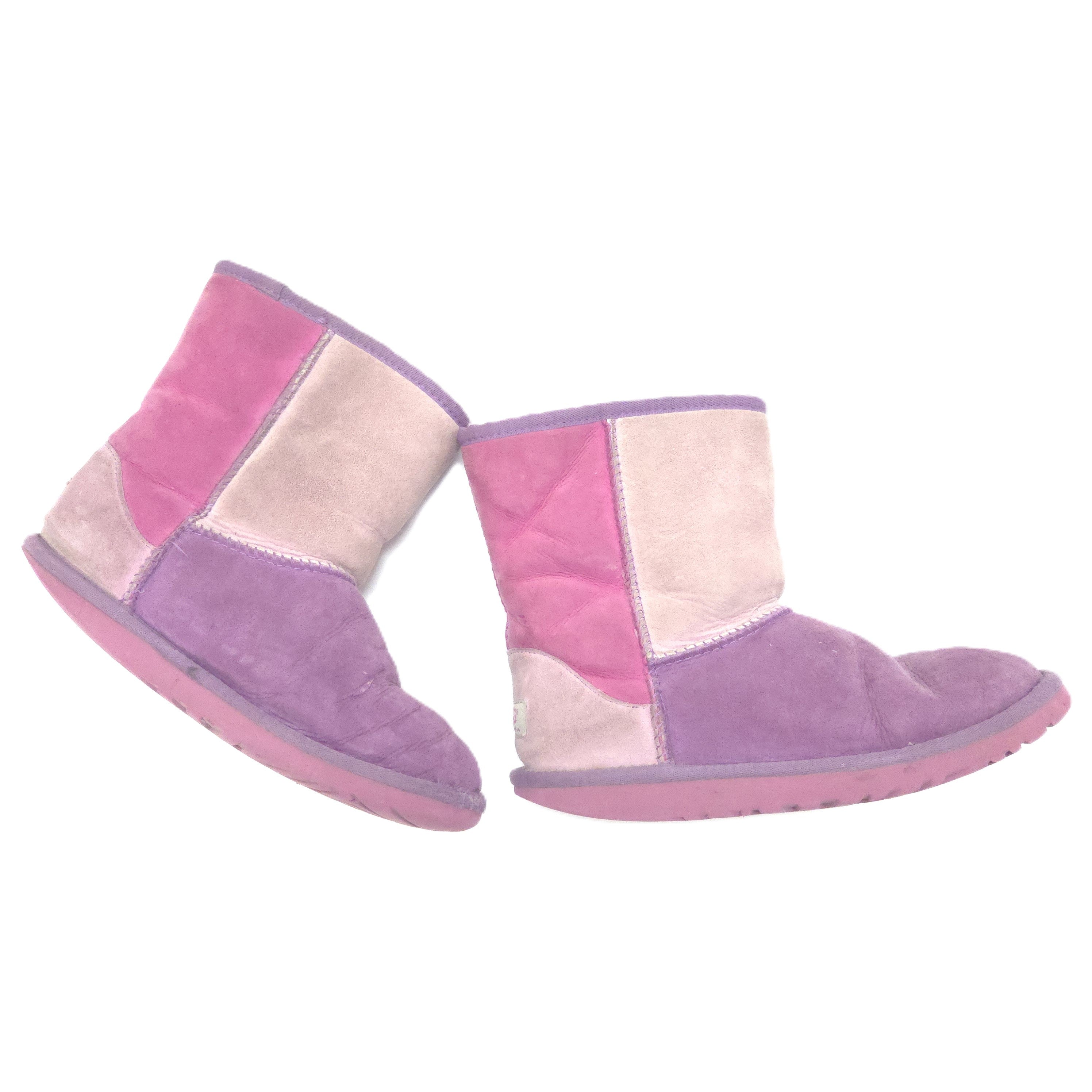 A pair of patchwork suede ankle boots in shades of pink, purple, and beige, shown against a plain white background.