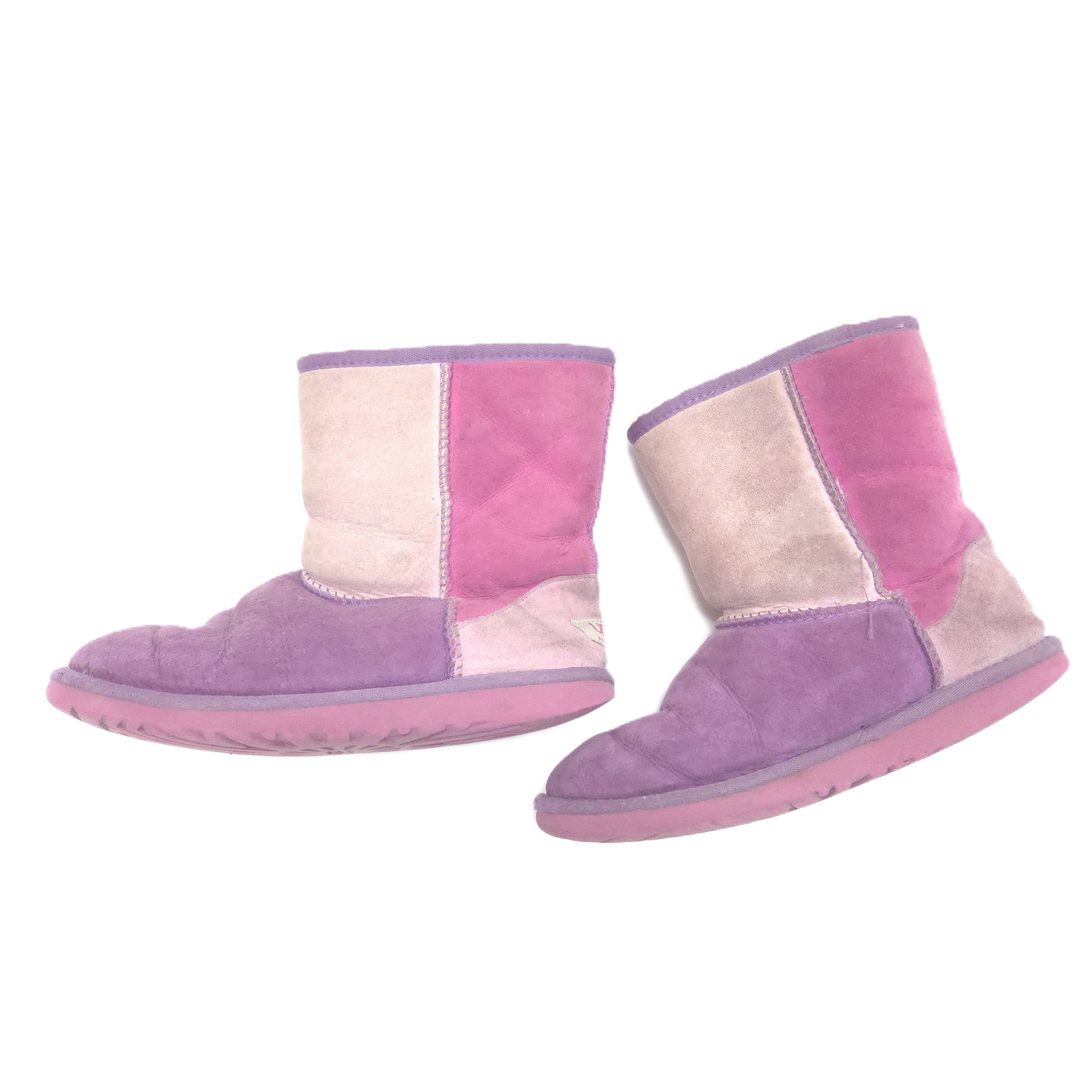 A pair of low-top patchwork suede boots in shades of purple, pink, and beige, shown against a plain white background.
